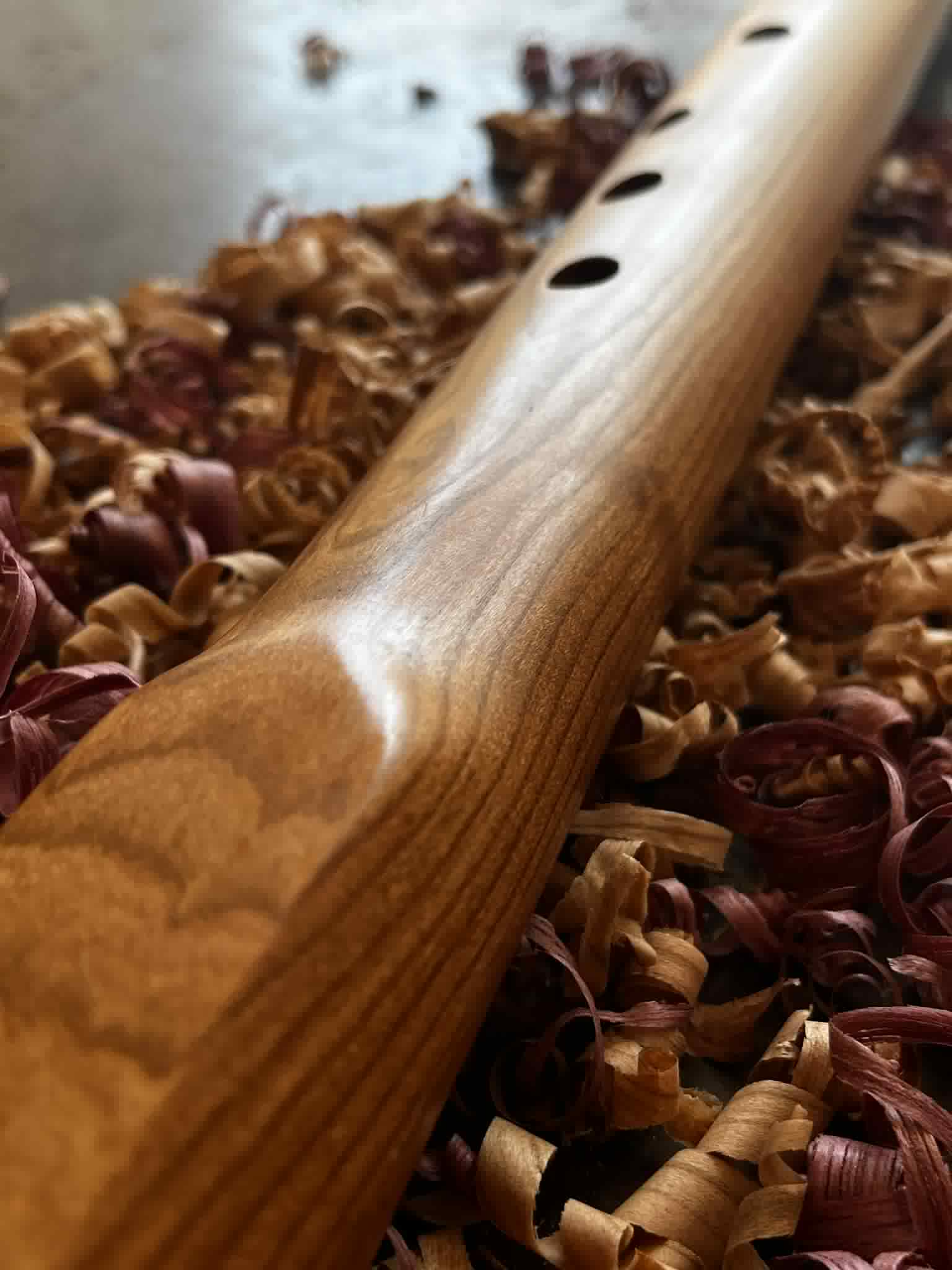 River Song — macro view along the spine showing three finger holes and a polished sanded finish